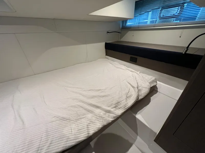 Slide: The Image of 2025 Beneteau Gran Turismo 36 cabin interior with bed and window blinds. - 23