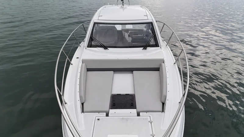 Slide: The Image of 2025 Beneteau Gran Turismo 36 yacht on calm water, showcasing sleek design and spacious deck. - 4