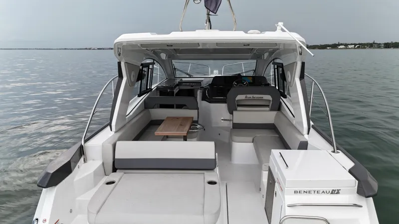 Slide: The Image of 2025 Beneteau Gran Turismo 36 yacht interior with seating and table on calm water. - 8