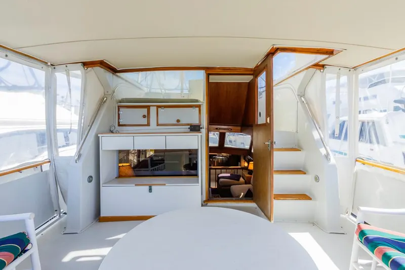 Slide: The Image of 1983 Uniflite 42 Aft Cabin interior with wooden accents and seating area. - 10