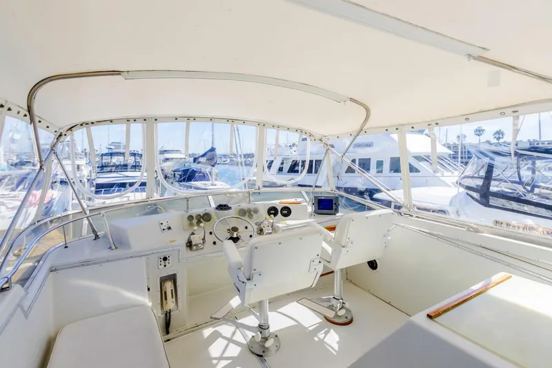 Slide: The Image of 1983 Uniflite 42 Aft Cabin yacht interior with helm, marina view. - 18