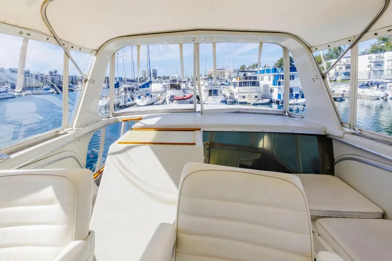 Slide: The Image of 1983 Uniflite 42 Aft Cabin yacht interior with marina view. - 23