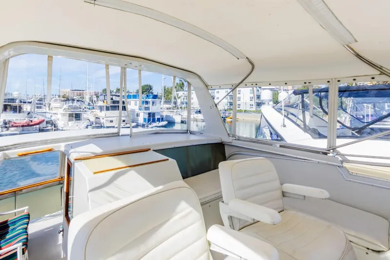 Slide: The Image of 1983 Uniflite 42 Aft Cabin yacht interior with marina view. - 24