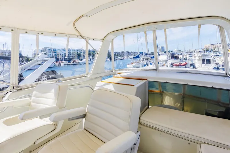 Slide: The Image of 1983 Uniflite 42 Aft Cabin yacht interior with marina view. - 25