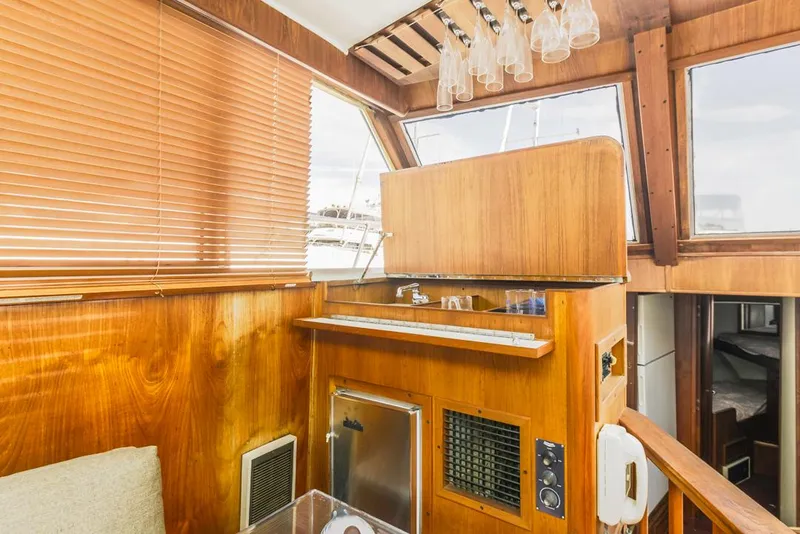 Slide: The Image of 1983 Uniflite 42 Aft Cabin interior with wood paneling and bar area. - 29