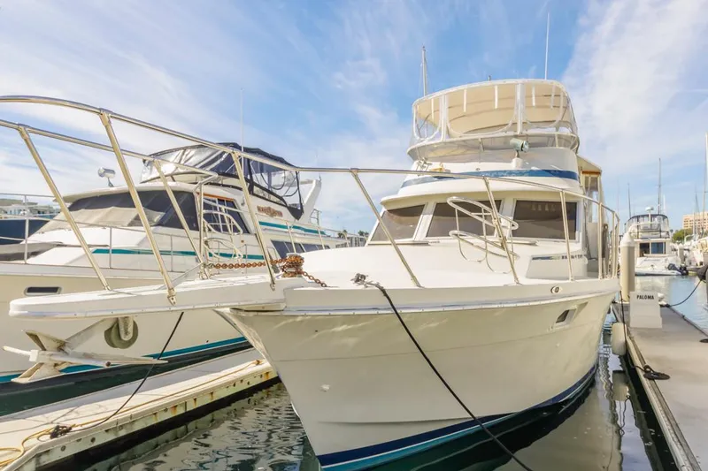 Slide: The Image of 1983 Uniflite 42 Aft Cabin yacht docked at marina under clear sky. - 3