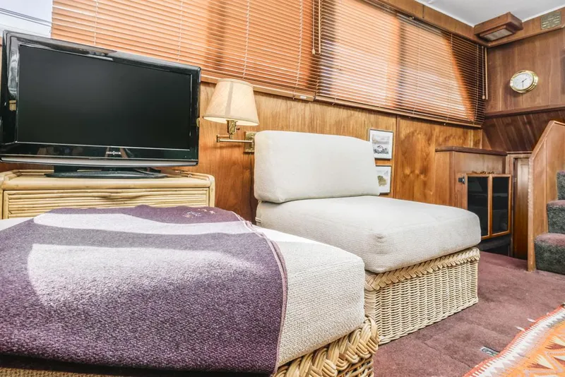 Slide: The Image of Cozy interior of 1983 Uniflite 42 Aft Cabin with TV and wicker furniture. - 35