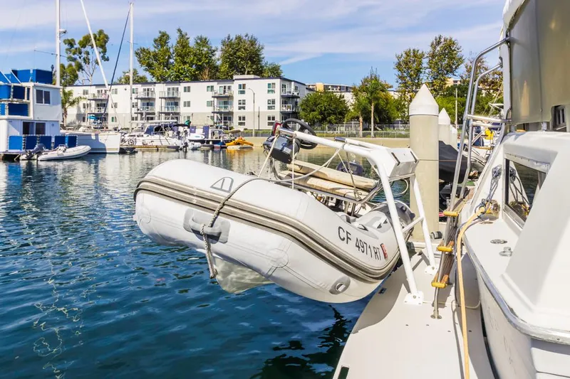 Slide: The Image of 1983 Uniflite 42 Aft Cabin with dinghy at marina dock. - 4