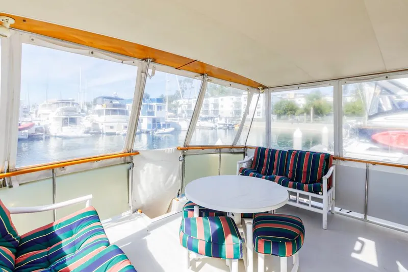 Slide: The Image of 1983 Uniflite 42 Aft Cabin yacht with colorful striped seating on deck. - 6