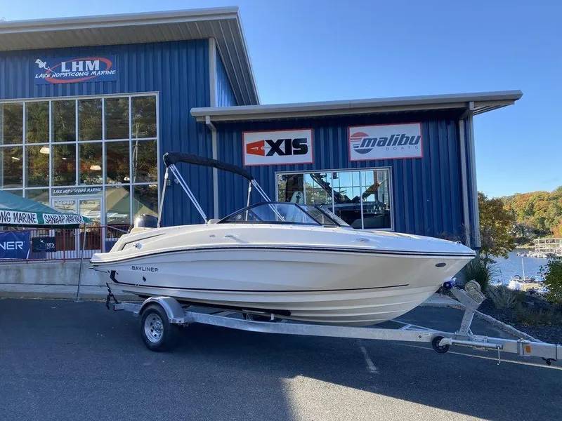 The Image of 2025 Bayliner VR5 Outboard boat on trailer outside dealership. - 1