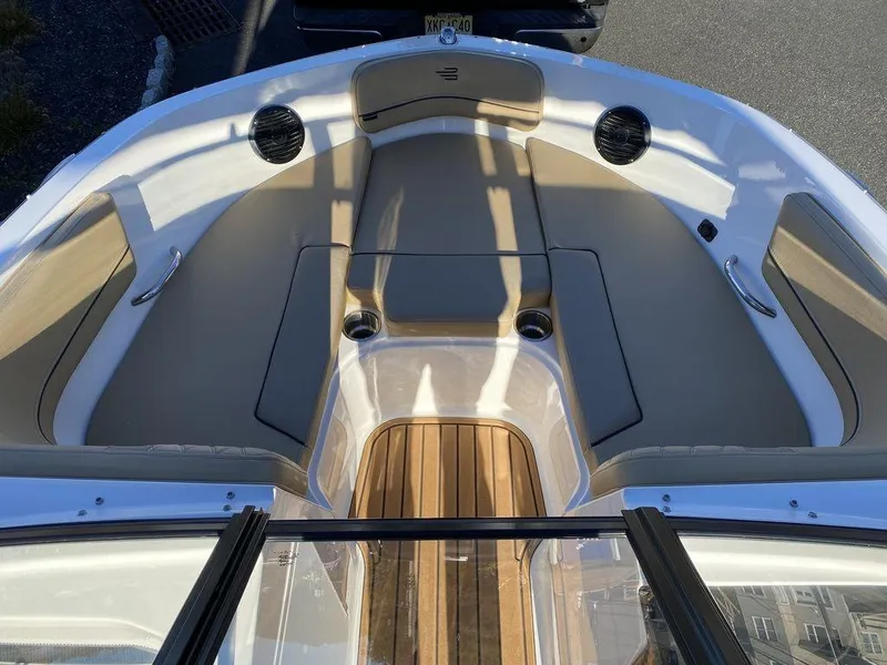 Slide: The Image of 2025 Bayliner VR5 Outboard boat interior with tan seating and wood accents. - 10