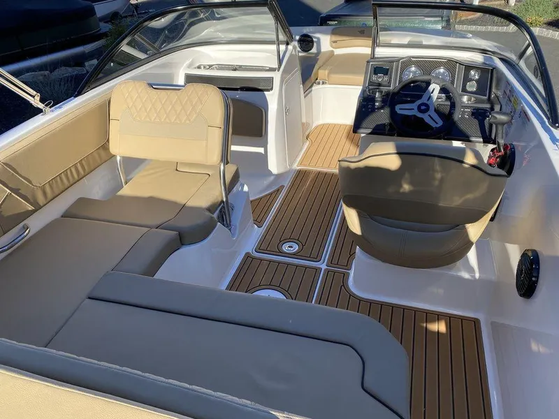 Slide: The Image of 2025 Bayliner VR5 Outboard interior with tan seating and wood-style flooring. - 14