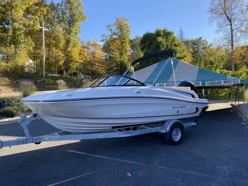 Slide: The Image of 2025 Bayliner VR5 Outboard boat on trailer at marina, surrounded by autumn trees. - 3