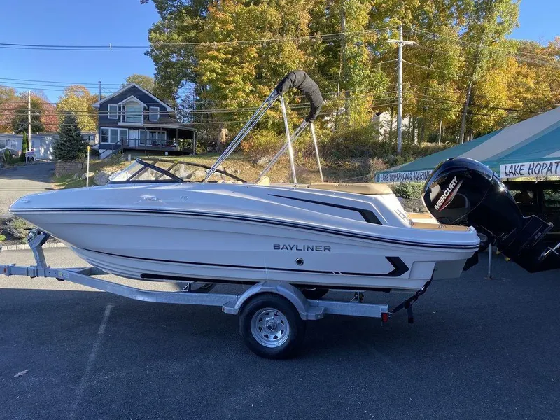 Slide: The Image of 2025 Bayliner VR5 Outboard boat on trailer, parked outdoors in a scenic area. - 4