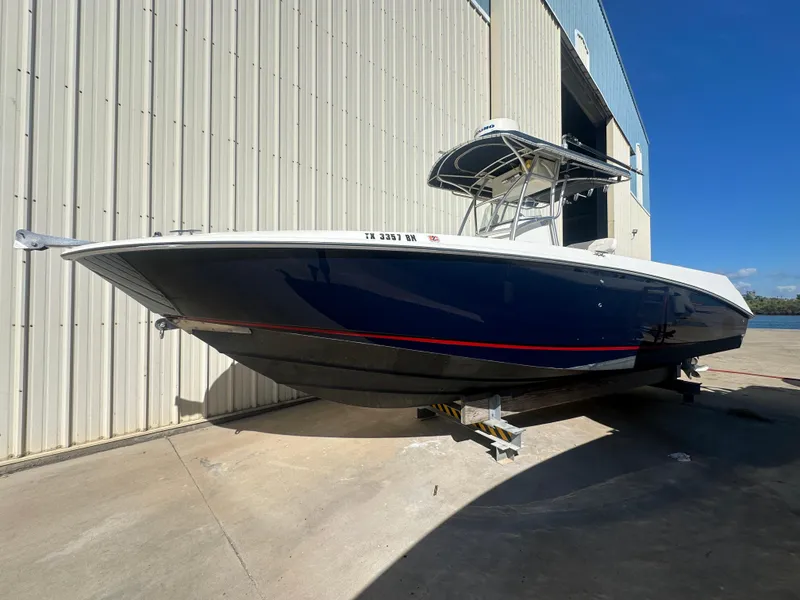 The Image of 2003 Boston Whaler 270 Outrage boat docked outside a warehouse. - 0
