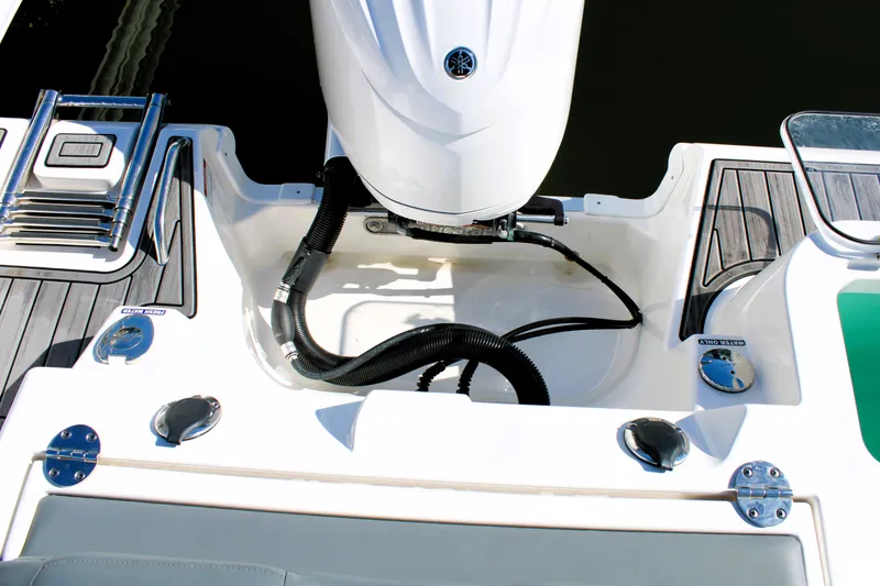 Slide: The Image of 2023 NauticStar 24 XS boat stern with motor and deck details. - 5
