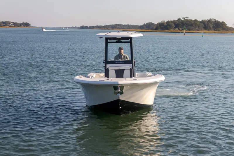 The Image of 2024 Tidewater 256 CC Adventure boat cruising on calm waters. - 0