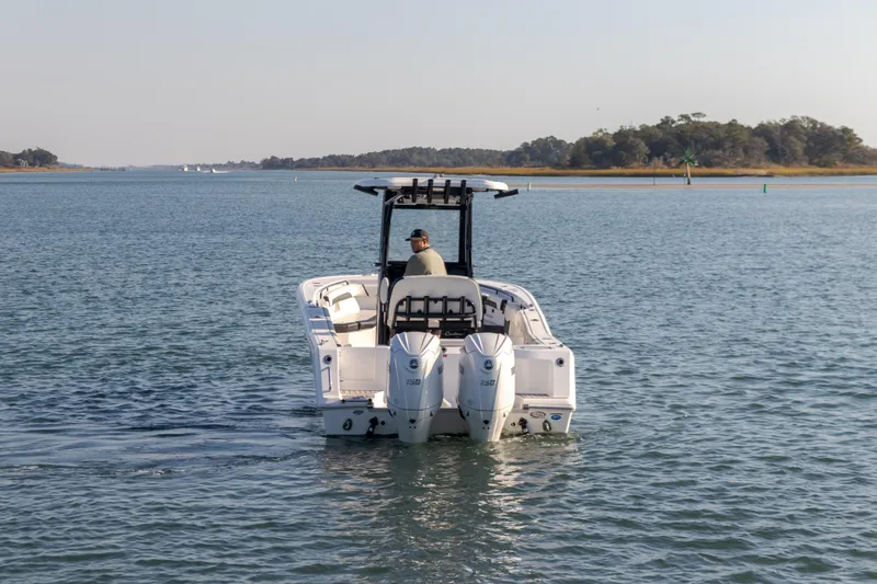 Slide: The Image of 2024 Tidewater 256 CC Adventure boat cruising on calm waters. - 1