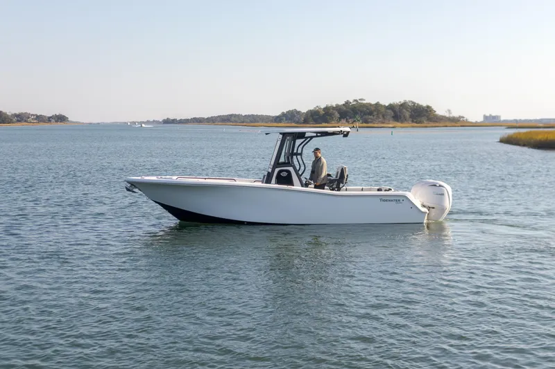 Slide: The Image of 2024 Tidewater 256 CC Adventure boat cruising on calm waters. - 3