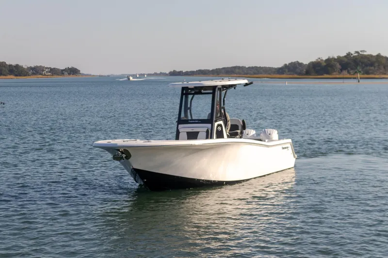 Slide: The Image of 2024 Tidewater 256 CC Adventure boat on calm water. - 5