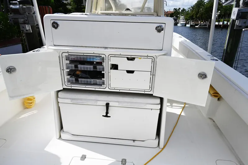 Slide: The Image of 2016 SeaVee 340Z boat storage compartments open, showcasing organized fishing gear. - 12