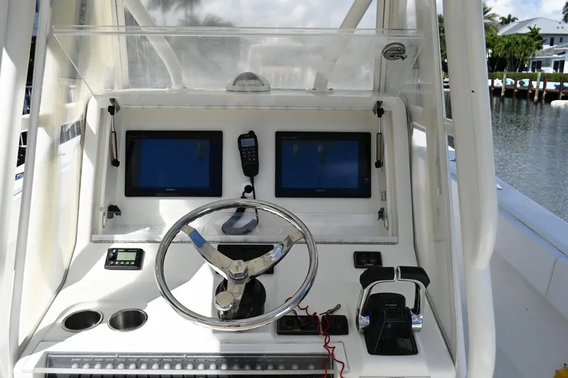 Slide: The Image of 2016 SeaVee 340Z boat dashboard with dual screens, steering wheel, and controls. - 15