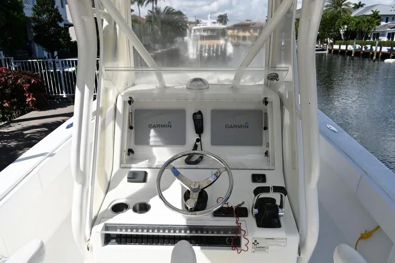 Slide: The Image of 2016 SeaVee 340Z boat console with Garmin navigation, steering wheel, and controls. - 16