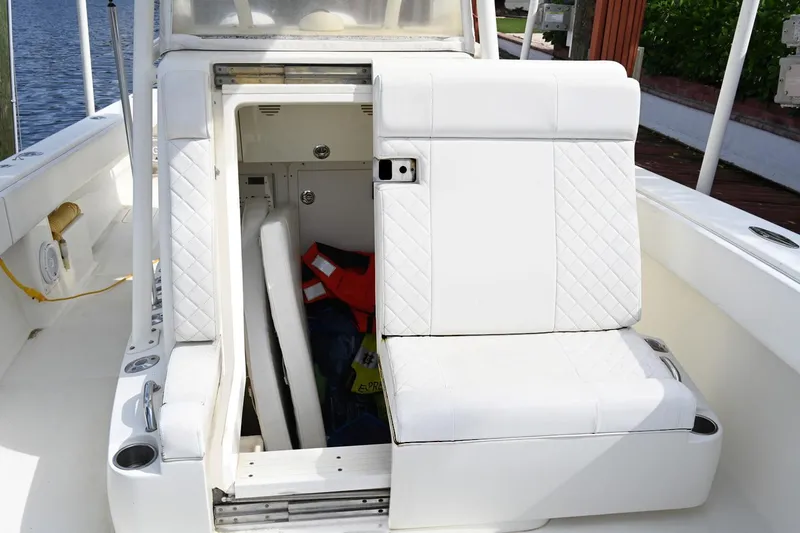 Slide: The Image of 2016 SeaVee 340Z boat interior with white seating and storage compartment. - 19