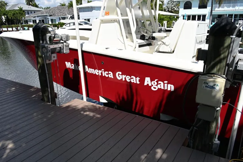 Slide: The Image of Red 2016 SeaVee 340Z boat docked, featuring "Make America Great Again" text. - 2