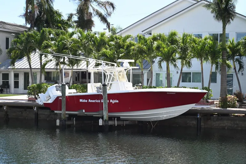 Slide: The Image of 2016 SeaVee 340Z boat docked by waterfront home, surrounded by palm trees. - 3