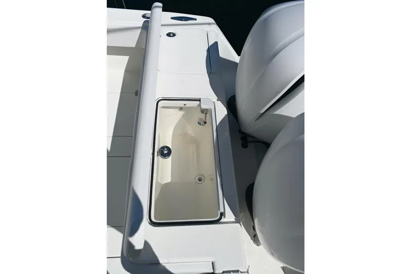 Slide: The Image of 2016 SeaVee 340Z boat deck with open storage compartment and dual engines. - 6