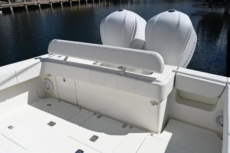 Slide: The Image of 2016 SeaVee 340Z boat deck with dual outboard engines, white seating, and storage compartments. - 7