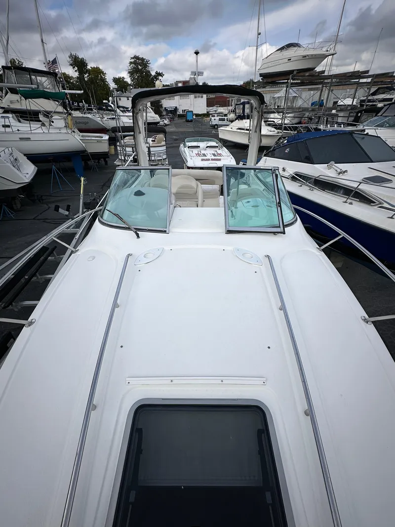 Slide: The Image of 2007 Chaparral Signature 270 boat docked at a marina, surrounded by other vessels. - 13