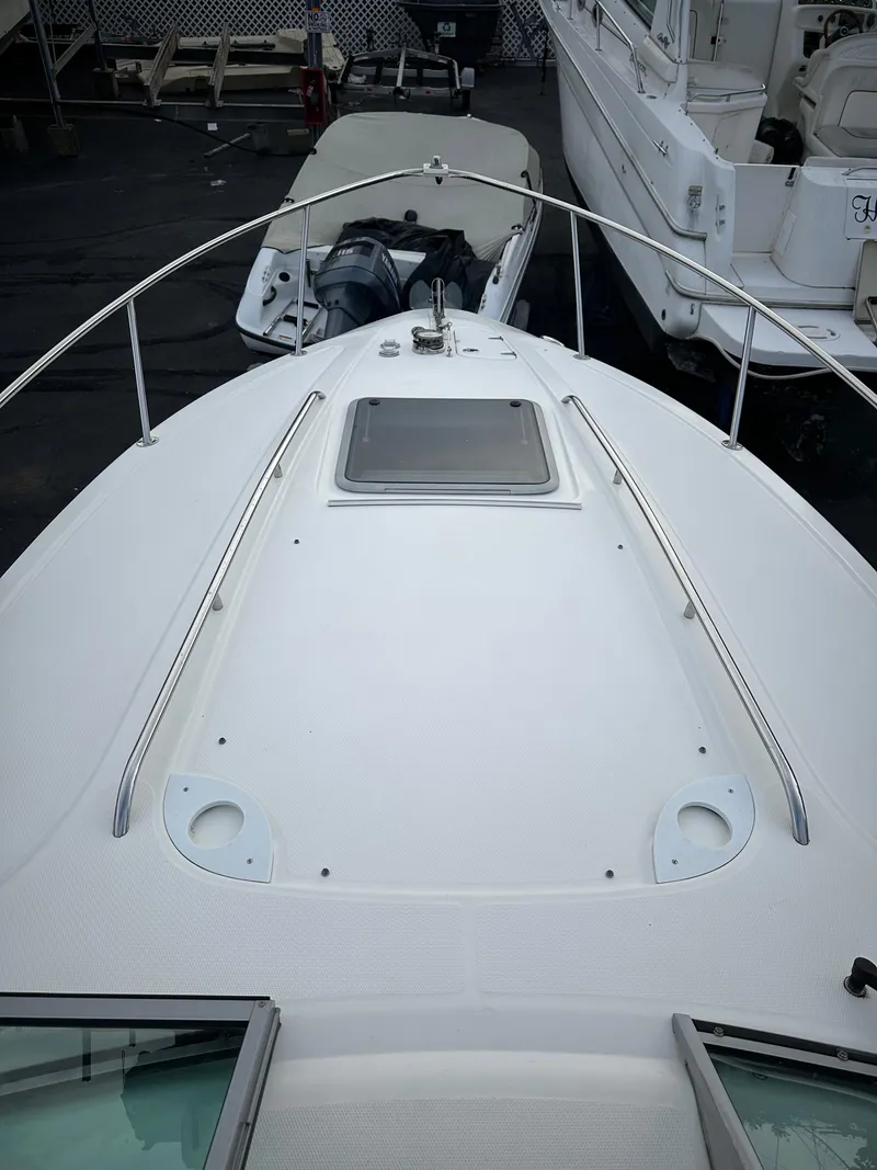 Slide: The Image of 2007 Chaparral Signature 270 boat deck with open hatch and railing. - 15