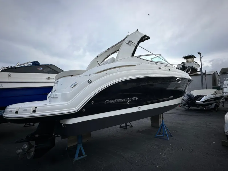 Slide: The Image of 2007 Chaparral Signature 270 boat on stands, displayed outdoors under cloudy sky. - 2