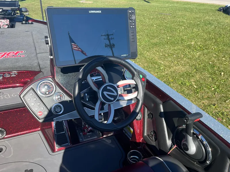 Slide: The Image of 2015 Ranger Z521 Comanche boat dashboard with steering wheel and navigation display. - 12