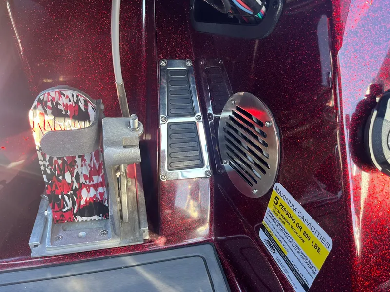 Slide: The Image of 2015 Ranger Z521 Comanche boat interior with pedal, vent, and capacity label. - 24