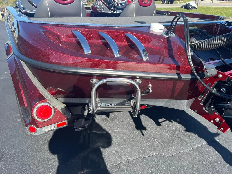 Slide: The Image of 2015 Ranger Z521 Comanche boat, rear view, red finish, parked on pavement. - 4