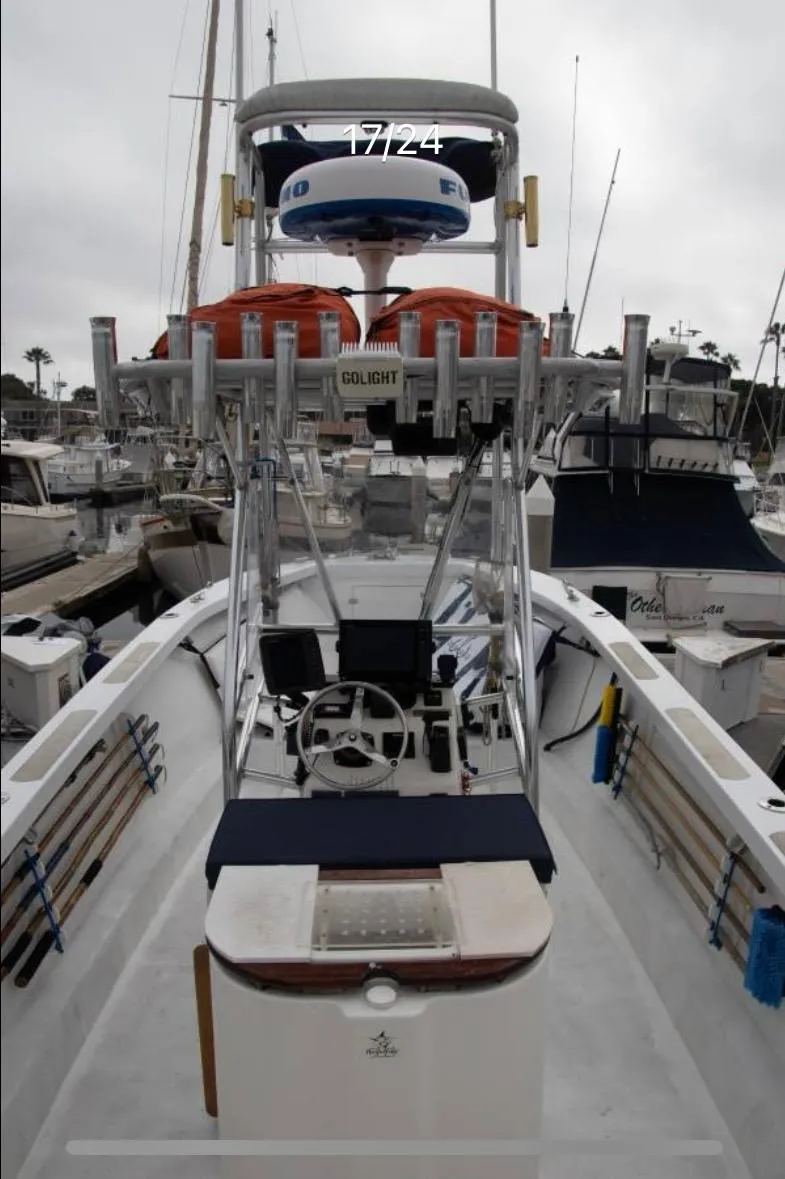 Slide: The Image of 1979 Chaparral 224 Fisherman boat with fishing gear, docked in a marina. - 12