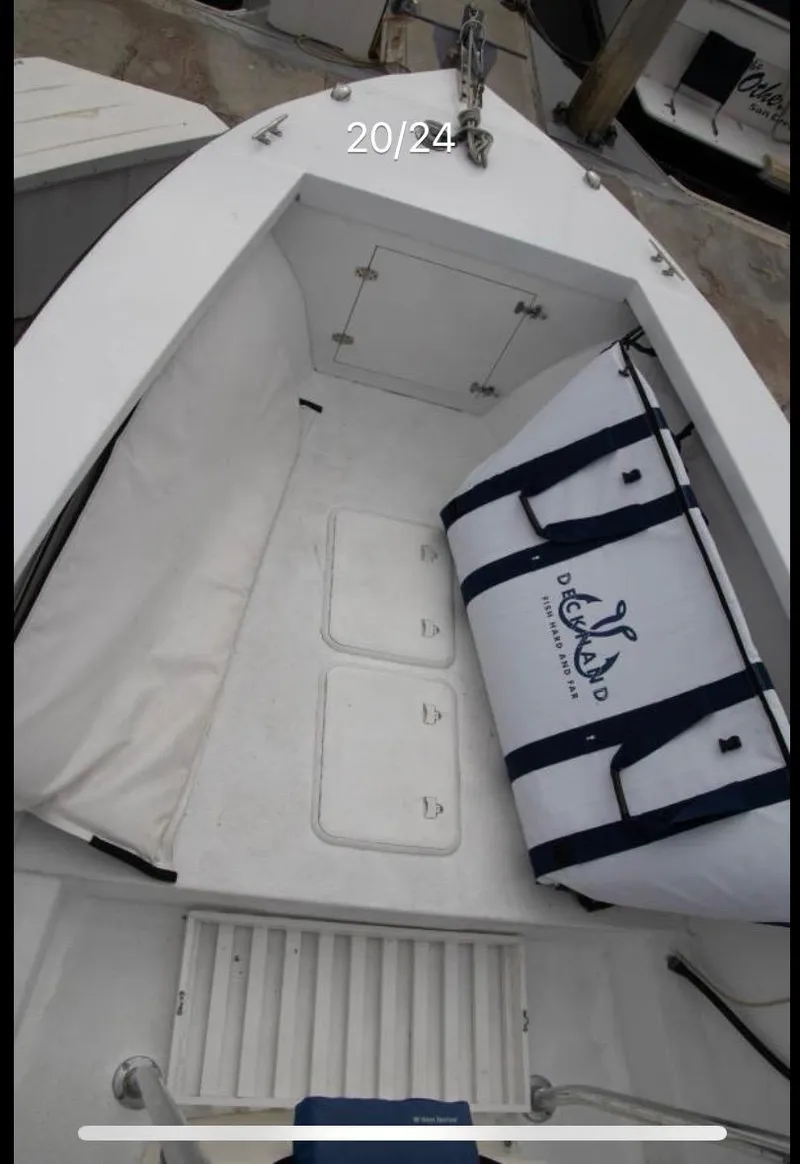 Slide: The Image of 1979 Chaparral 224 Fisherman boat interior with storage and cooler bag. - 13