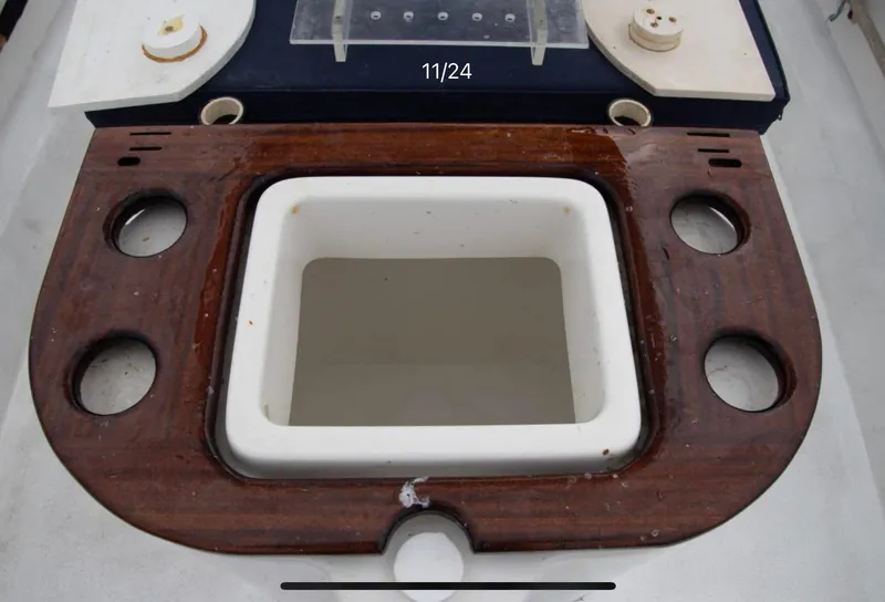 Slide: The Image of 1979 Chaparral 224 Fisherman boat console with wooden trim and cup holders. - 9