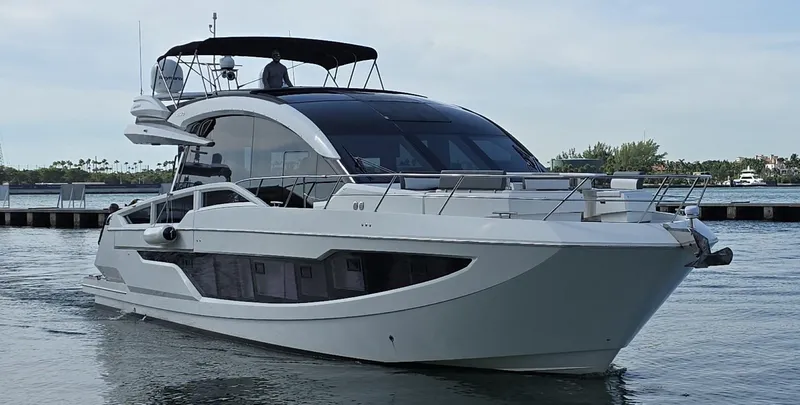 Slide: The Image of 2019 Galeon 650 Sky yacht cruising on calm waters. - 12