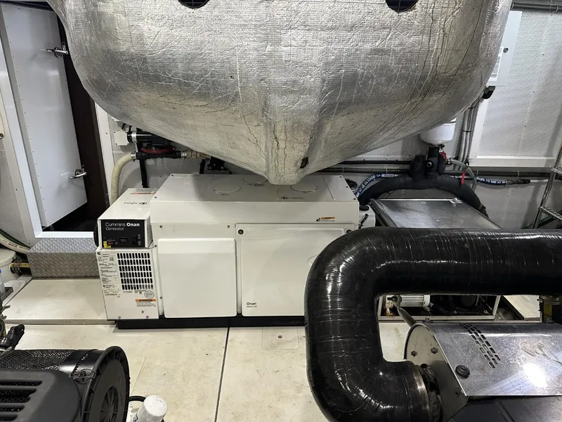 Slide: The Image of Engine room of 2019 Galeon 650 Sky yacht, featuring generator and machinery. - 26