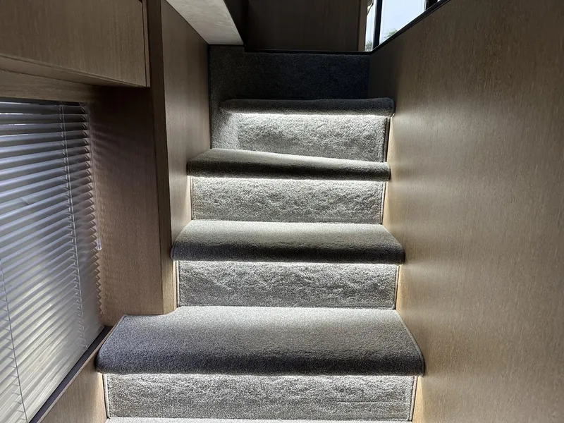 Slide: The Image of Carpeted stairs with ambient lighting inside 2019 Galeon 650 Sky yacht. - 31