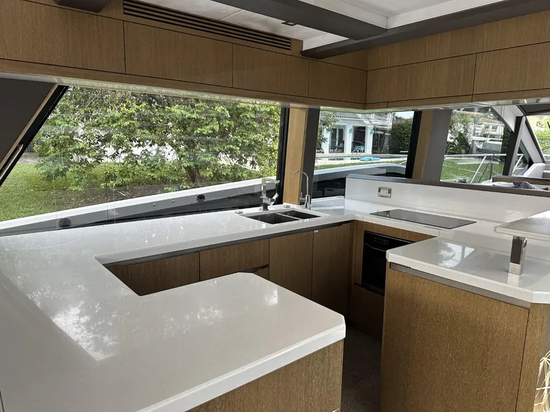 Slide: The Image of Modern kitchen interior of 2019 Galeon 650 Sky yacht with sleek countertops and large windows. - 33