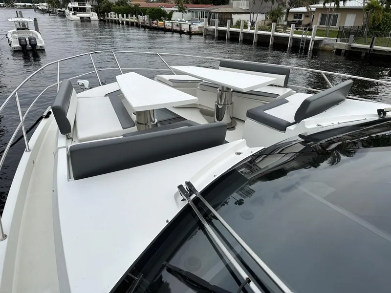 Slide: The Image of 2019 Galeon 650 Sky yacht with sleek deck seating and waterfront view. - 38