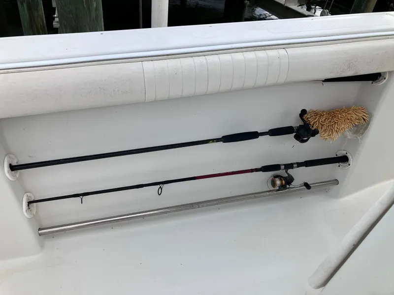 Slide: The Image of Fishing rods and cleaning brush stored on a 2005 Sailfish 266 CC boat. - 15