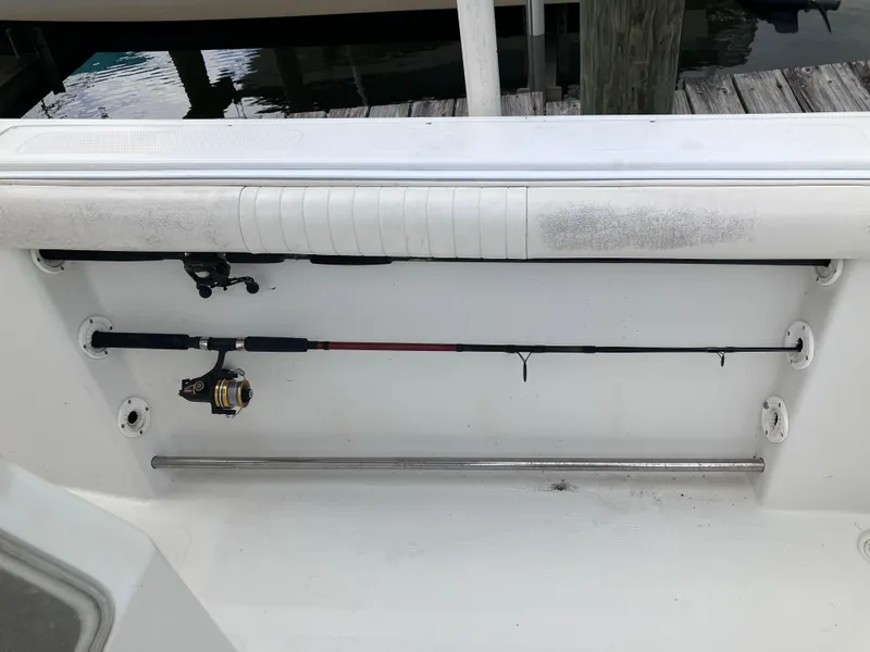 Slide: The Image of Fishing rods stored on a 2005 Sailfish 266 CC boat deck. - 16