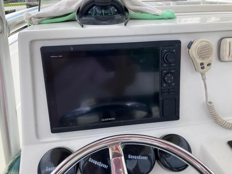 Slide: The Image of Garmin GPS on 2005 Sailfish 266 CC boat dashboard with steering wheel and radio. - 26