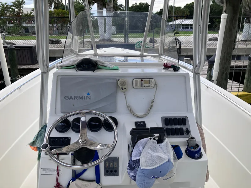 Slide: The Image of 2005 Sailfish 266 CC boat dashboard with Garmin navigation system and steering wheel. - 27